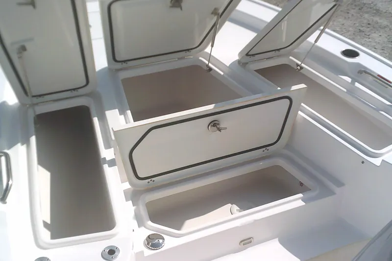 Slide: The Image of 2025 Sportsman Masters 227 Bay Boat storage compartments open, showcasing spacious design. - 5