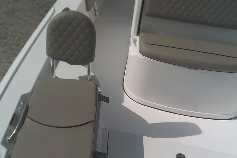 Slide: The Image of 2025 Sportsman Masters 227 Bay Boat interior with cushioned seating and sleek design. - 6