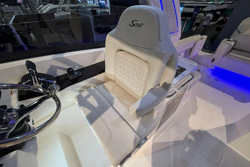 Slide: The Image of 2026 Scout 288 Dorado boat interior with luxurious captain's seat and steering wheel. - 11