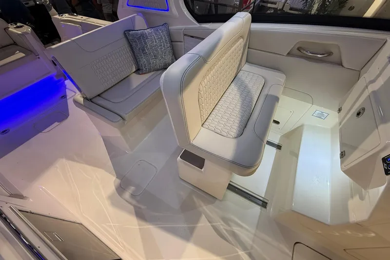 Slide: The Image of 2026 Scout 288 Dorado boat interior with luxurious seating and ambient blue lighting. - 14