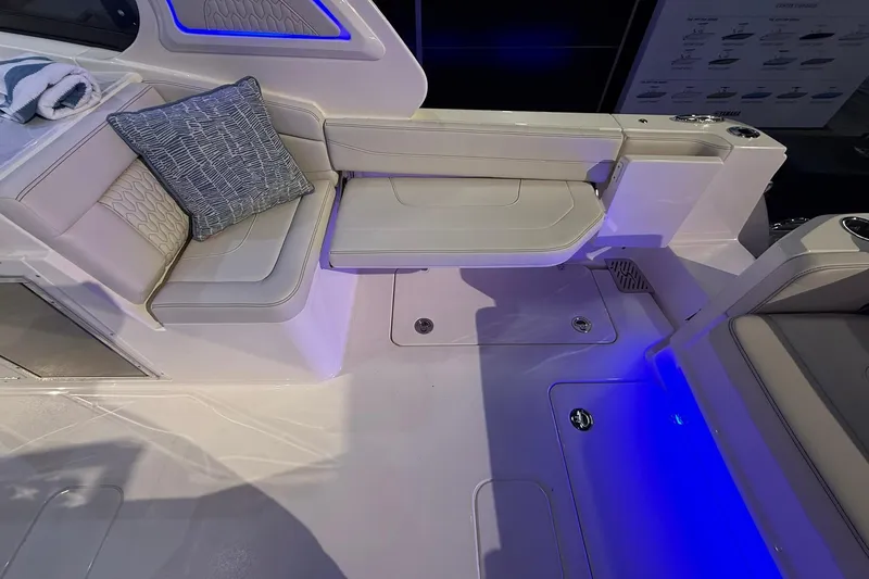 Slide: The Image of Interior of 2026 Scout 288 Dorado boat with plush seating and ambient blue lighting. - 20