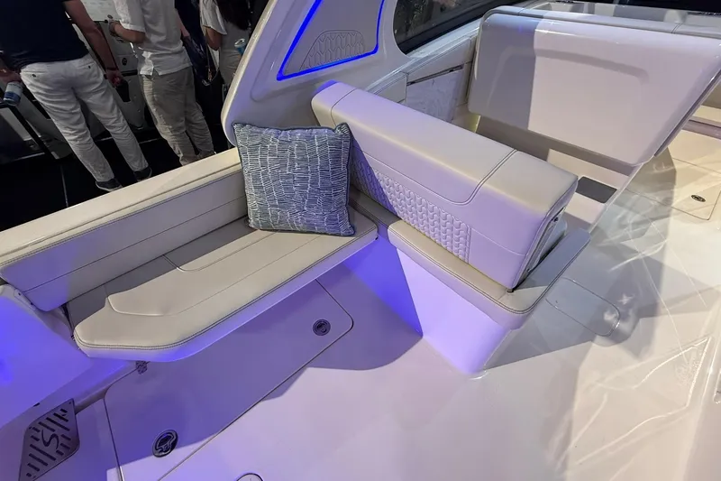 Slide: The Image of 2026 Scout 288 Dorado boat interior with plush seating and decorative pillow. - 21