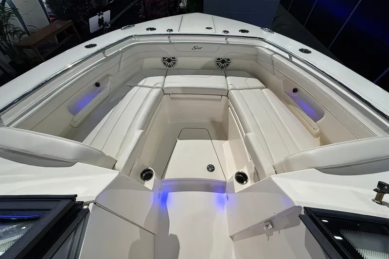 Slide: The Image of 2026 Scout 288 Dorado boat interior with white seating and ambient lighting. - 4