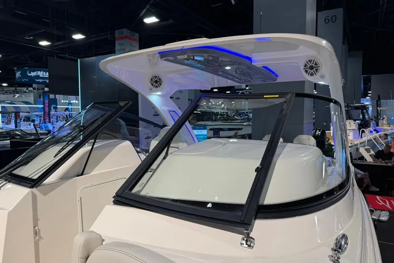 Slide: The Image of 2026 Scout 288 Dorado boat showcased indoors with modern design and blue LED lighting. - 5