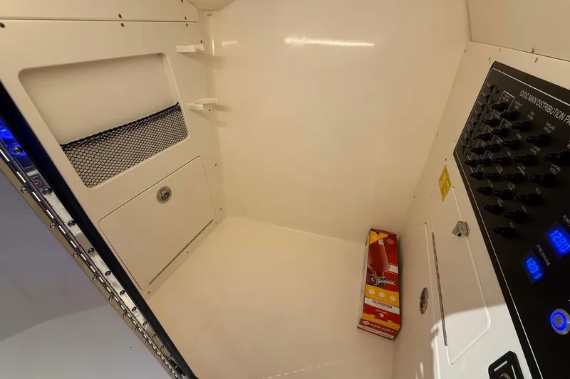 Slide: The Image of Interior of 2026 Scout 288 Dorado boat with control panel and storage area. - 8