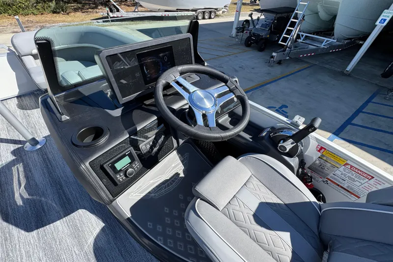Slide: The Image of 2026 Bennington 22 MSB boat dashboard with steering wheel and control panel. - 23