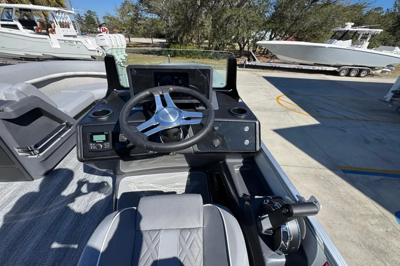 Slide: The Image of 2026 Bennington 22 MSB boat cockpit with steering wheel and control panel. - 24