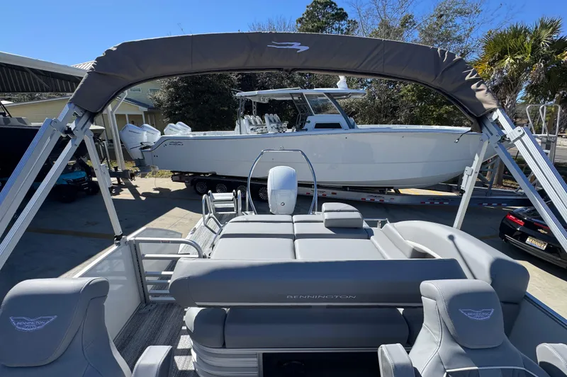 Slide: The Image of 2026 Bennington 22 MSB pontoon boat with gray seating and canopy. - 27