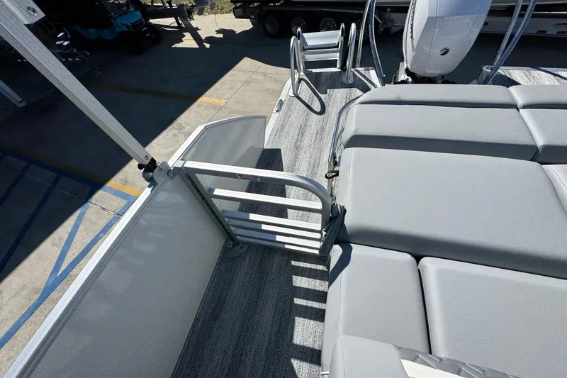 Slide: The Image of 2026 Bennington 22 MSB pontoon boat with gray seating and safety gate. - 29
