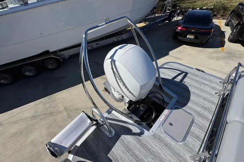 Slide: The Image of 2026 Bennington 22 MSB boat with Mercury outboard motor on a trailer. - 33