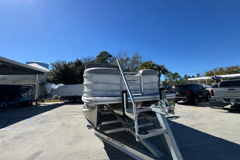 Slide: The Image of 2026 Bennington 22 MSB pontoon boat on trailer under clear blue sky. - 6