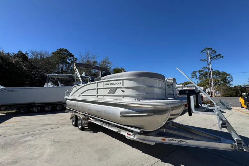 Slide: The Image of 2026 Bennington 22 MSB pontoon boat on trailer under clear blue sky. - 7