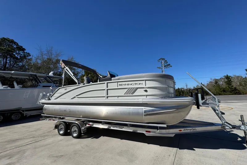 Slide: The Image of 2026 Bennington 22 MSB pontoon boat on trailer under clear blue sky. - 8