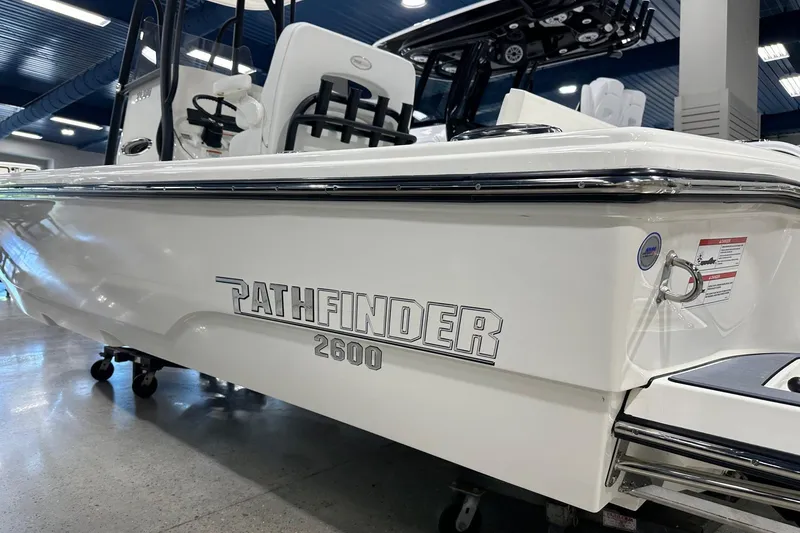 Slide: The Image of 2026 Pathfinder 2600 TRS boat displayed indoors, showcasing sleek design and branding. - 19