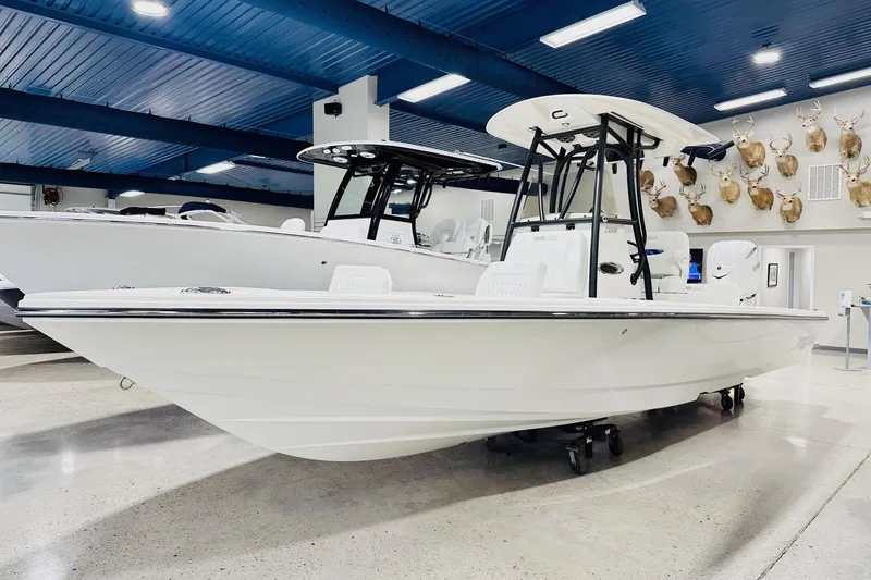 The Image of 2026 Pathfinder 2600 TRS boat displayed in a showroom with blue ceiling. - 2