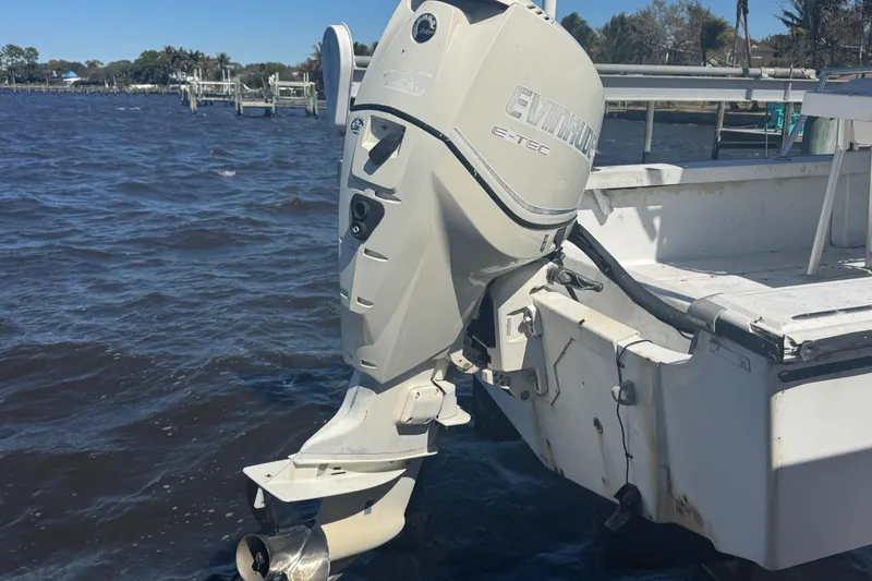 Slide: The Image of 1988 Boston Whaler Outrage 17 with Evinrude E-TEC outboard motor on a sunny day. - 10