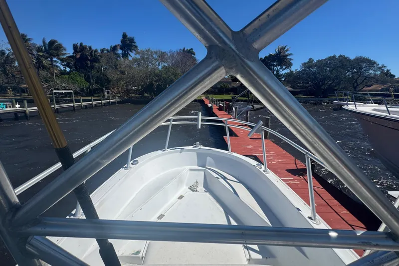 Slide: The Image of 1988 Boston Whaler Outrage 17 docked, view from bow, sunny day, calm waters. - 22