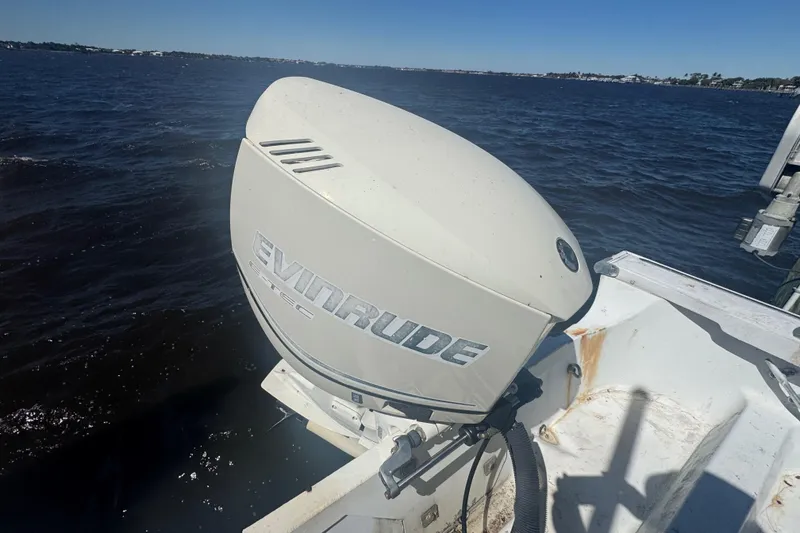 Slide: The Image of 1988 Boston Whaler Outrage 17 with Evinrude outboard motor on open water. - 24