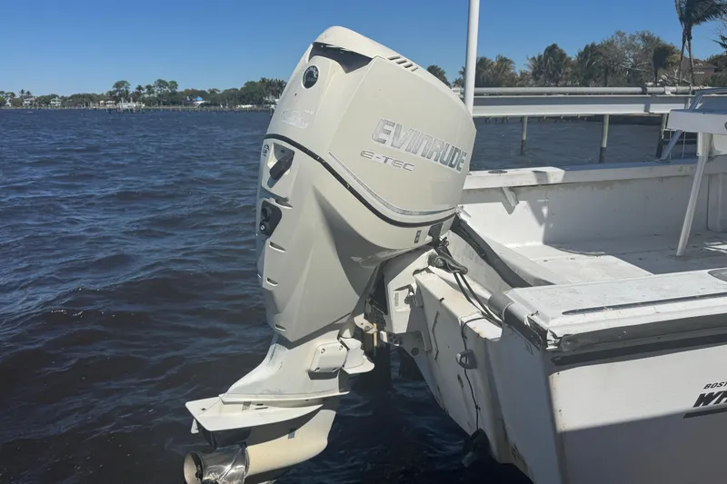 Slide: The Image of 1988 Boston Whaler Outrage 17 with Evinrude E-TEC outboard motor on water. - 25