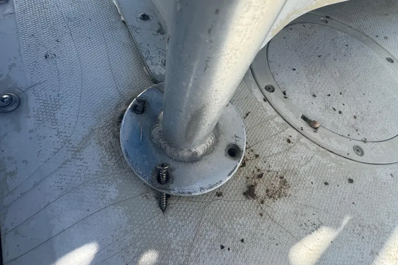 Slide: The Image of 1988 Boston Whaler Outrage 17 deck with metal pole and screws. - 28