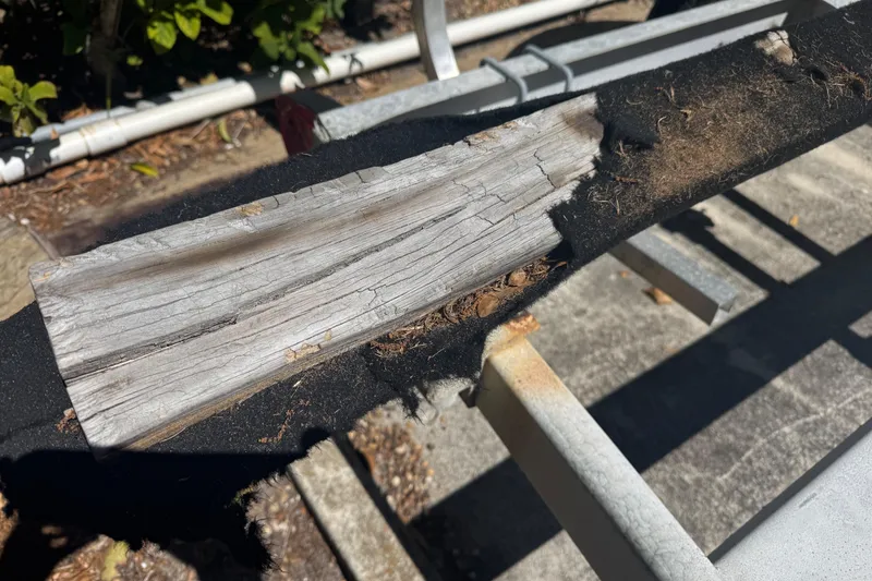 Slide: The Image of Worn boat trailer bunk with exposed wood and frayed carpet, Boston Whaler Outrage 17, 1988. - 29