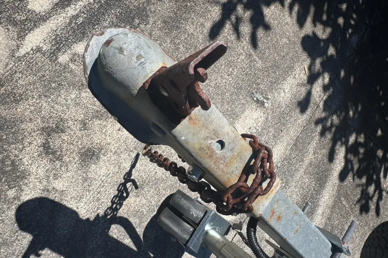 Slide: The Image of Rusty trailer hitch with chain for 1988 Boston Whaler Outrage 17 boat. - 30