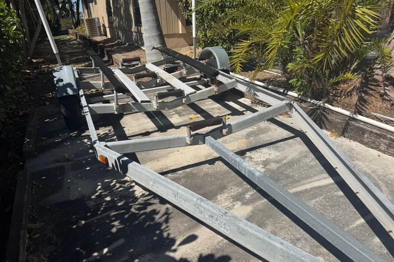 Slide: The Image of Boat trailer for 1988 Boston Whaler Outrage 17, parked outdoors. - 33