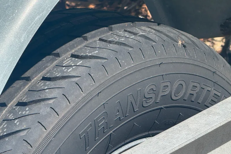 Slide: The Image of Close-up of a tire on a 1988 Boston Whaler Outrage 17 trailer. - 36