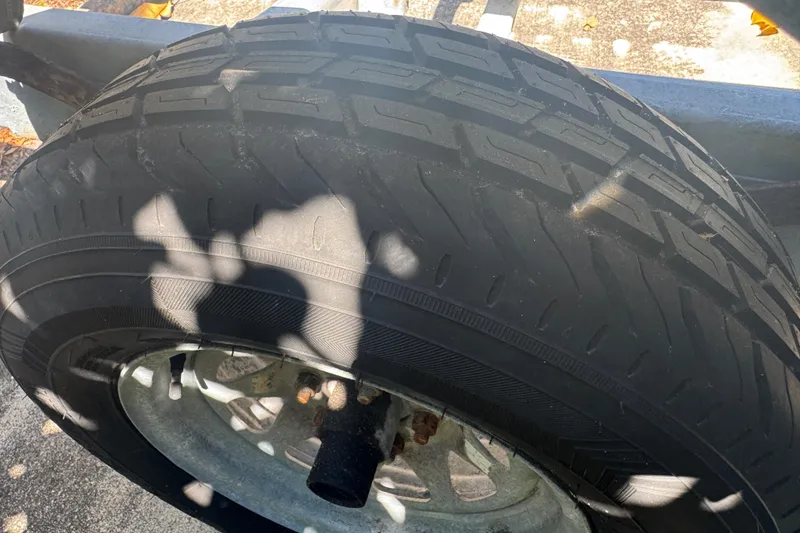 Slide: The Image of Trailer tire for 1988 Boston Whaler Outrage 17, showing tread pattern and wheel rim. - 37