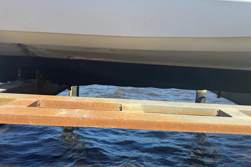 Slide: The Image of 1988 Boston Whaler Outrage 17 on a dock above water. - 6