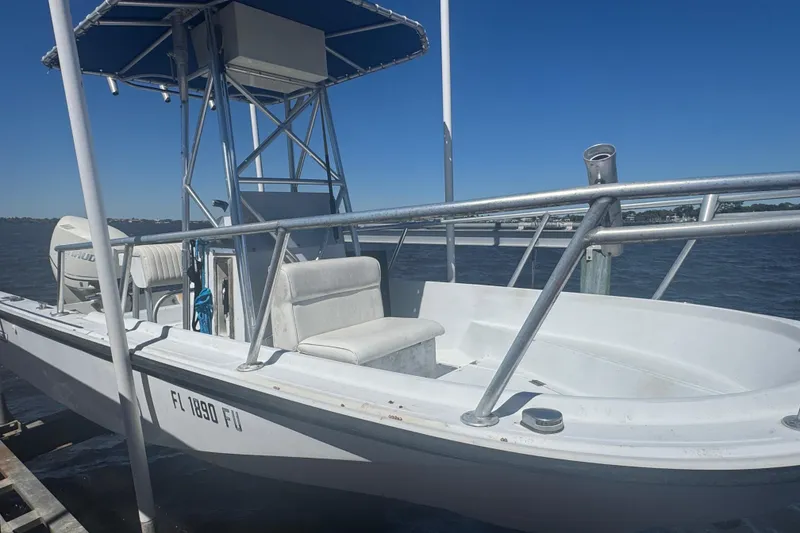 Slide: The Image of 1988 Boston Whaler Outrage 17 boat docked on a sunny day. - 8
