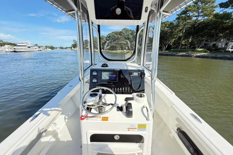 Slide: The Image of 2020 Parker 2100 Special Edition boat interior with steering wheel and control panel on a sunny day. - 11