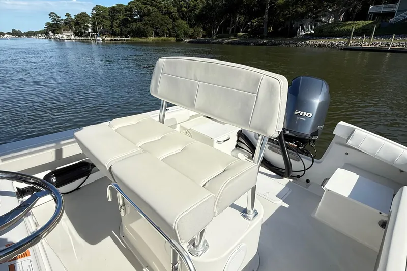 Slide: The Image of 2020 Parker 2100 Special Edition boat with cushioned seating and powerful outboard motor. - 15