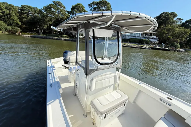 Slide: The Image of 2020 Parker 2100 Special Edition boat on calm water near a wooded shoreline. - 16