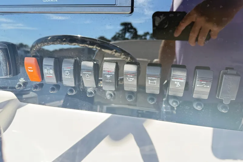 Slide: The Image of Control panel of a 2020 Parker 2100 Special Edition boat with various switches. - 32
