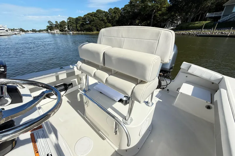 Slide: The Image of 2020 Parker 2100 Special Edition boat interior with steering wheel and cushioned seating. - 34