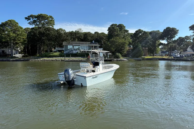 Slide: The Image of 2020 Parker 2100 Special Edition boat on a calm lake near a wooded shoreline. - 42