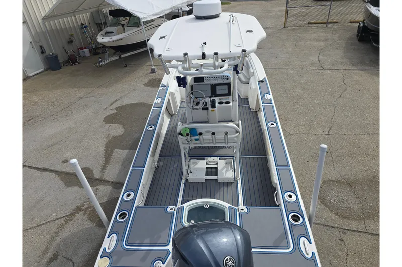 Slide: The Image of 2012 Everglades 243 Center Console boat with advanced navigation equipment, docked in a marina. - 11