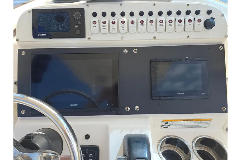 Slide: The Image of 2012 Everglades 243 Center Console dashboard with Garmin displays and Yamaha controls. - 12