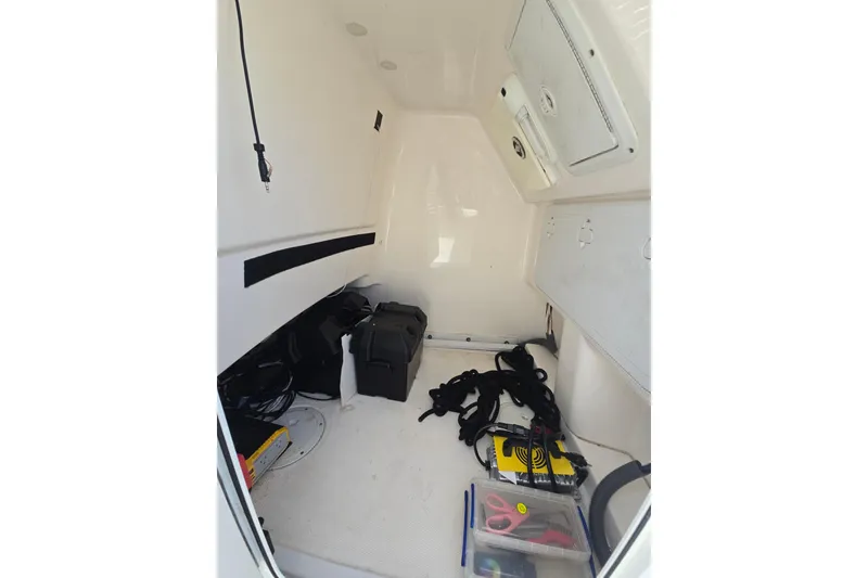Slide: The Image of Interior of 2012 Everglades 243 Center Console boat with storage and equipment. - 13