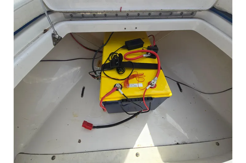 Slide: The Image of Battery compartment of 2012 Everglades 243 Center Console boat with yellow battery. - 16