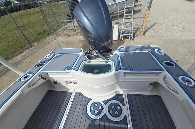 Slide: The Image of 2012 Everglades 243 Center Console boat with Yamaha 300 engine, docked on concrete. - 17