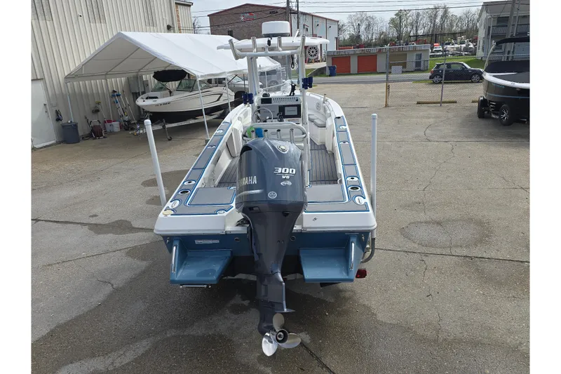 Slide: The Image of 2012 Everglades 243 Center Console boat with Yamaha 300 engine, parked outdoors. - 4