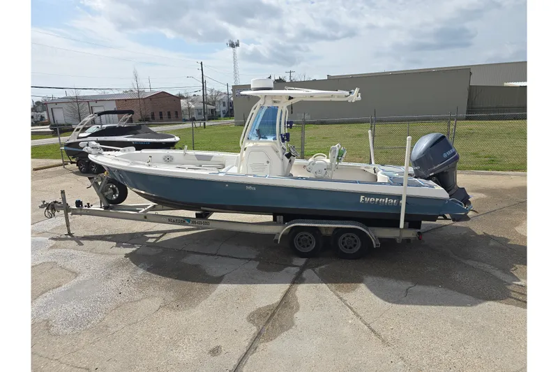 Slide: The Image of 2012 Everglades 243 Center Console boat on trailer, parked outdoors. - 6