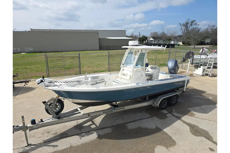 Slide: The Image of 2012 Everglades 243 Center Console boat on trailer, parked outdoors. - 7