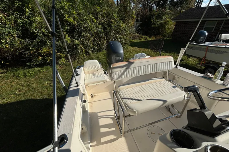 Slide: The Image of 2005 Sea Hunt Triton 202 boat interior with seating and outboard motor. - 11