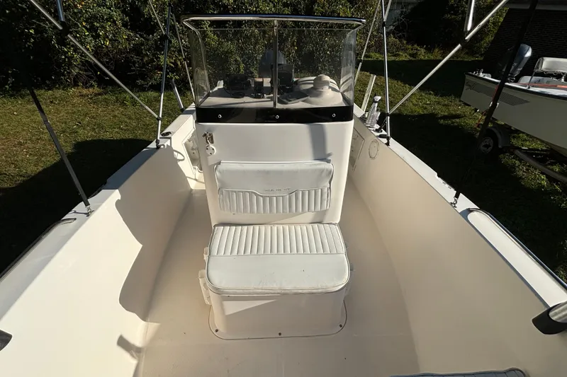Slide: The Image of 2005 Sea Hunt Triton 202 boat interior with seating and console, outdoors. - 15
