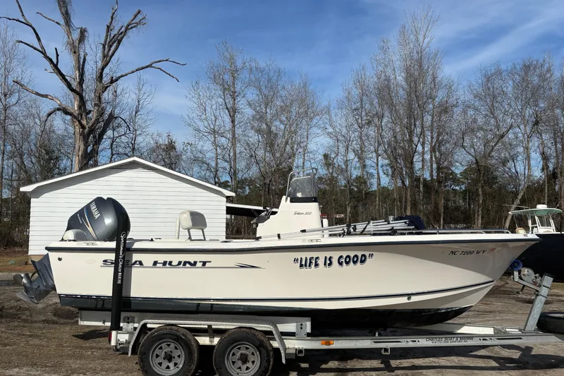 Slide: The Image of 2005 Sea Hunt Triton 202 boat on trailer, "Life is Good" text, parked outdoors. - 6