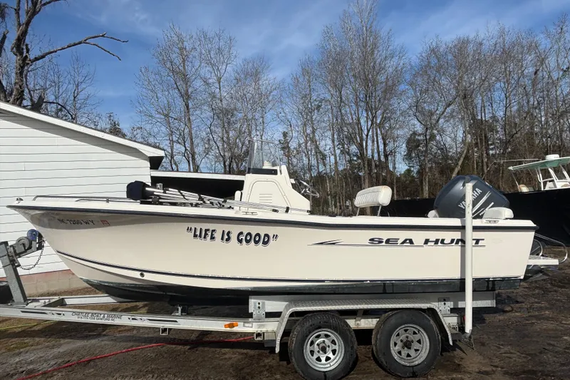 Slide: The Image of 2005 Sea Hunt Triton 202 boat on trailer, labeled "Life is Good," with Yamaha motor. - 7