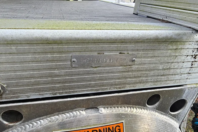 Slide: The Image of 2023 Bennington 21 SLX boat with visible identification plate and warning label. - 10